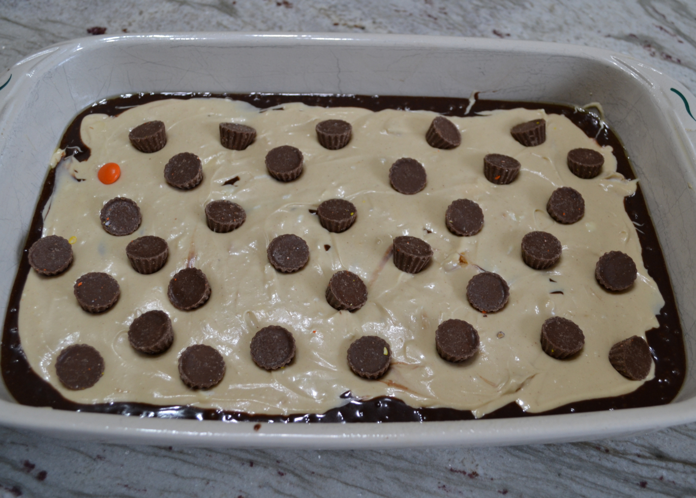 Extreme Peanut Butter Cream Cheese Brownies are extreme because they are a decadent brownie dessert, loaded with a peanut butter cream cheese layer, and then topped with a bag of Reese’s Baking Cups and Reese’s Pieces Candies