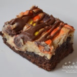 Extreme Peanut Butter Cream Cheese Brownies are extreme because they are a decadent brownie dessert, loaded with a peanut butter cream cheese layer, and then topped with a bag of Reese’s Baking Cups and Reese’s Pieces Candies