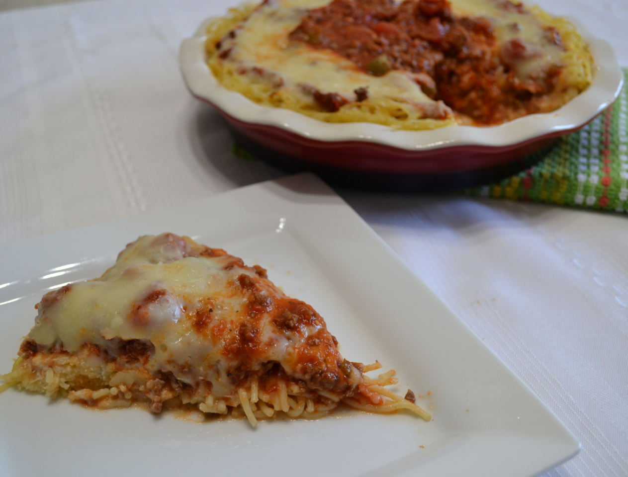 Cheesy Spaghetti Pie is baked in a deep dish pie plate with a crust of spaghetti,a layer of ricotta,then topped with homemade pasta sauce and mozzarella cheese.