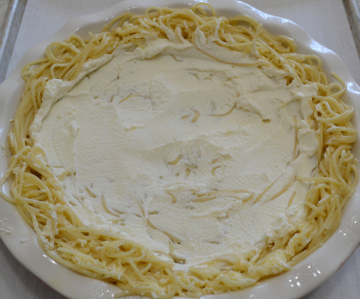 Cheesy Spaghetti Pie is baked in a deep dish pie plate with a crust of spaghetti,a layer of ricotta,then topped with homemade pasta sauce and mozzarella cheese.