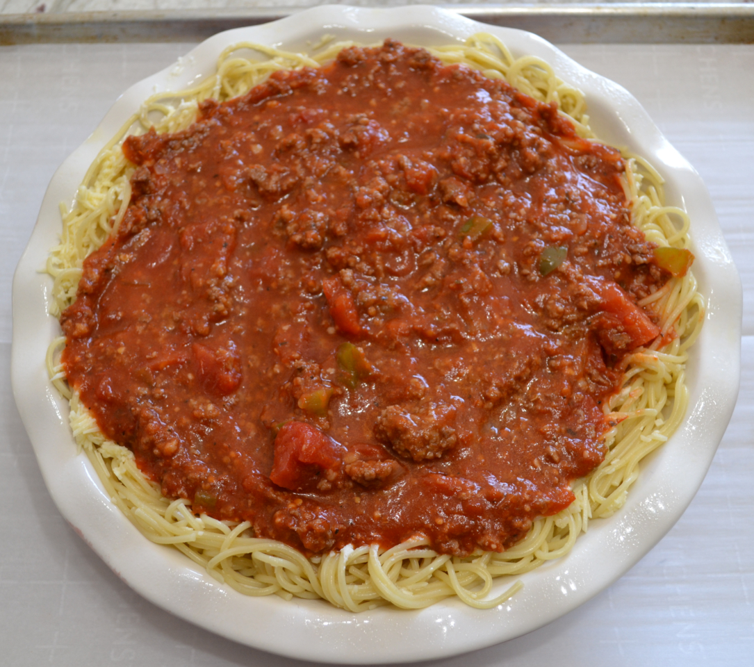 Cheesy Spaghetti Pie is baked in a deep dish pie plate with a crust of spaghetti,a layer of ricotta,then topped with homemade pasta sauce and mozzarella cheese.