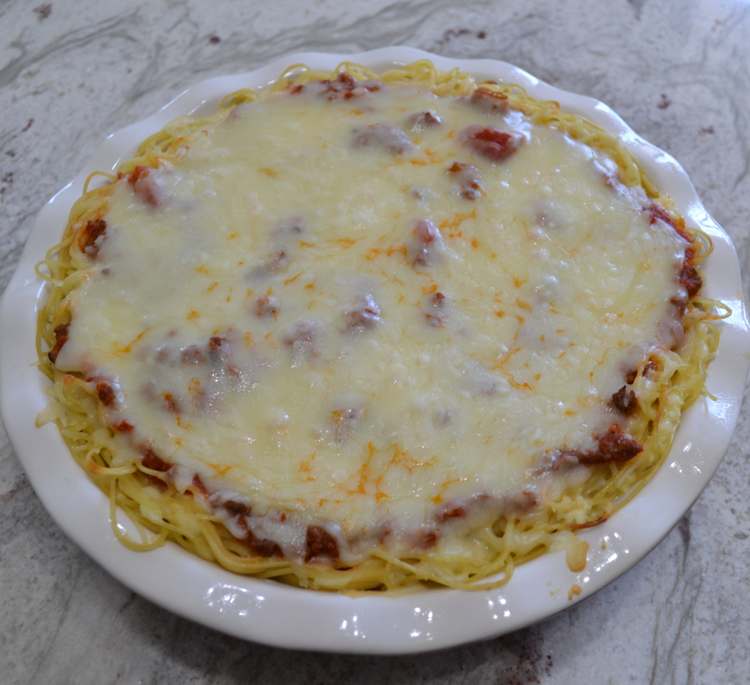 Cheesy Spaghetti Pie is baked in a deep dish pie plate with a crust of spaghetti,a layer of ricotta,then topped with homemade pasta sauce and mozzarella cheese.