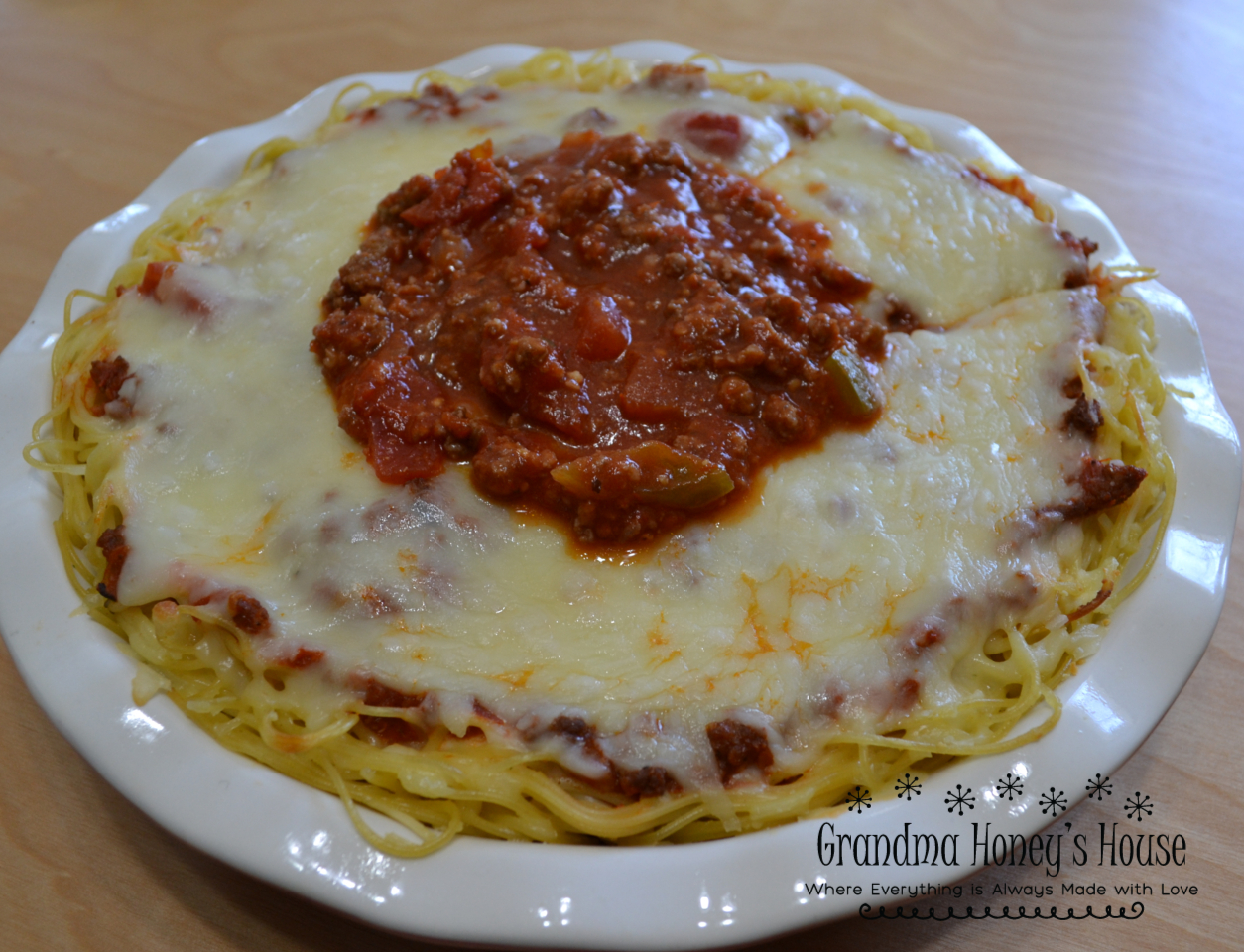 Cheesy Spaghetti Pie is baked in a deep dish pie plate with a crust of spaghetti,a layer of ricotta,then topped with homemade pasta sauce and mozzarella cheese.