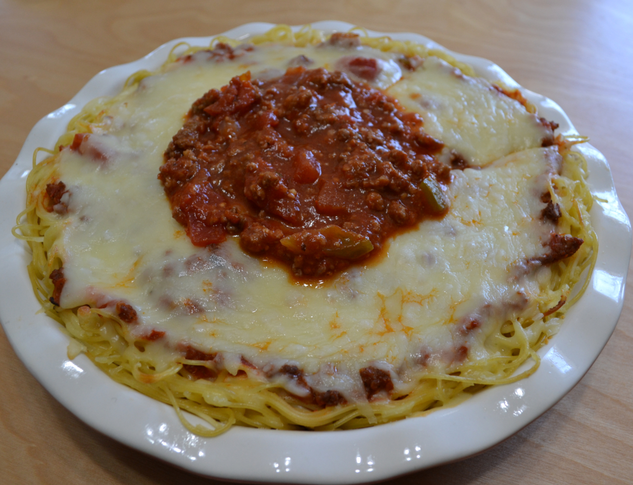 Cheesy Spaghetti Pie is baked in a deep dish pie plate with a crust of spaghetti,a layer of ricotta,then topped with homemade pasta sauce and mozzarella cheese. 