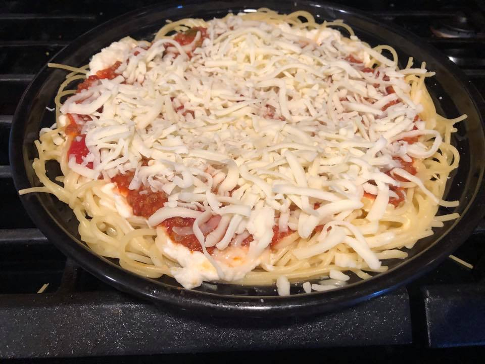 Cheesy Spaghetti Pie is baked in a deep dish pie plate with a crust of spaghetti,a layer of ricotta,then topped with homemade pasta sauce and mozzarella cheese.