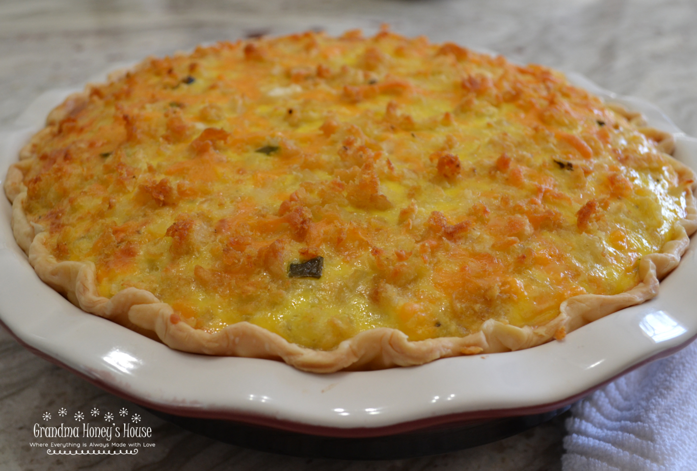 A loaded quiche with sausage, ham, peppers, spinach, cheese, eggs and half and half.  Top it off with a mixture of crumbled tater tots, cheddar cheese, and diced jalapenos for a  special brunch dish
