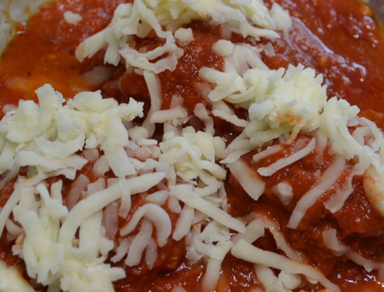 Cheesy Chicken Meatballs are moist, packed with flavor,cheese, and baked in pasta sauce.