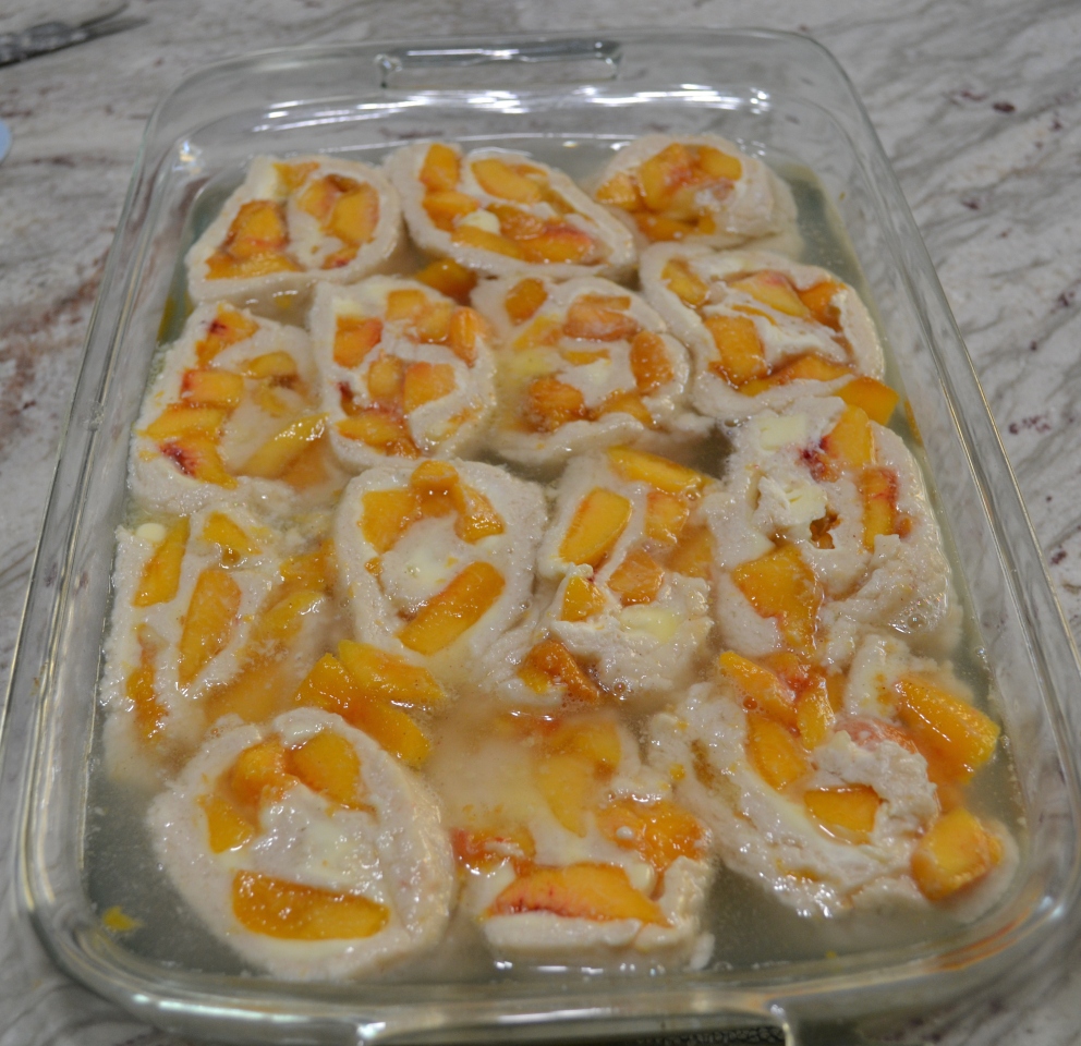 A delicious dessert made with fresh peaches and mascarpone cheese, rolled up in a shortbread crust. Baked in a simple syrup then drizzled with a mascarpone glaze.