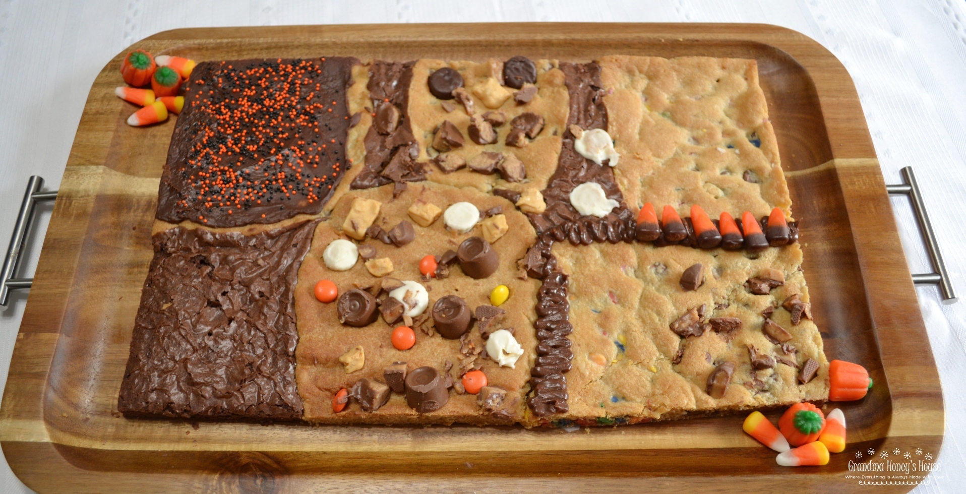 This Halloween Candy Bar Cookie is a mixture of different cookie dough, and brownie mix baked together on a sheet pan. Different candies and chips are added to dough or top the treat.