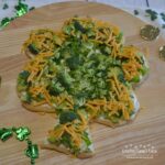 Shamrock Veggie Pizza is an easy appetizer made on a crescent dough crust, cream cheese and ranch filling, topped with green veggies for St Patrick's Day.