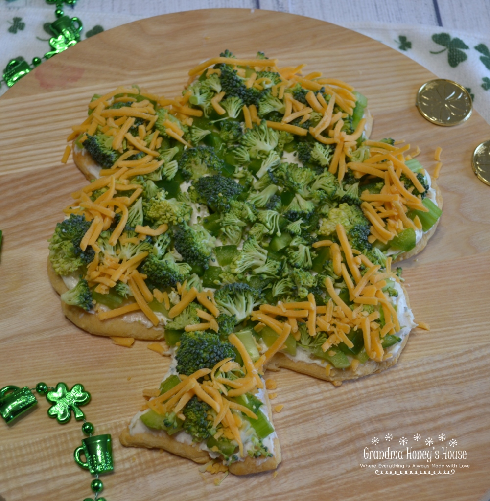 Shamrock Veggie Pizza is an easy appetizer made on a crescent dough crust, cream cheese and ranch filling, topped with green veggies for St Patrick's Day.