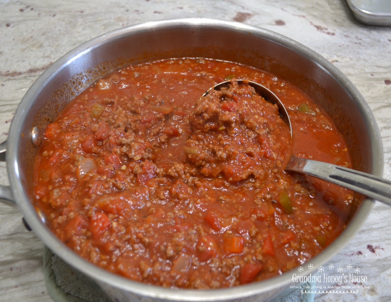A thick meaty, sauce with sweet italian sausage, ground beef, onions, peppers, garlic, tomatoes, seasonings, and jarred pasta sauces.  