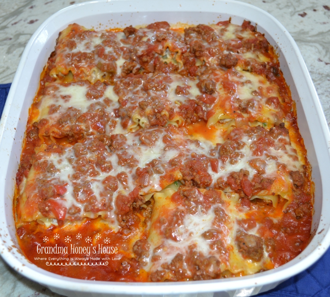 Sausage-Spinach Lasagna Roll-ups are a mixture of cheeses, egg, baby spinach, and sausage spread on lasagna noodles. They are rolled up,covered with pasta sauce and topped with more cheese and baked. 