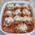 Sausage-Spinach Lasagna Roll-ups are a mixture of cheeses, egg, baby spinach, and sausage spread on lasagna noodles. They are rolled up,covered with pasta sauce and topped with more cheese and baked.