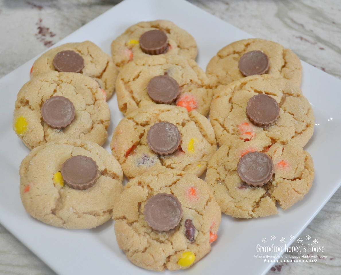 Triple Peanut Butter Cookie Delights are soft, chewy peanut butter cookies loaded with three favorite candies: Reese's Pieces, M&M's, and mini peanut butter cups. They are colorful, fun to make, and absolutely perfect for Halloween baking.