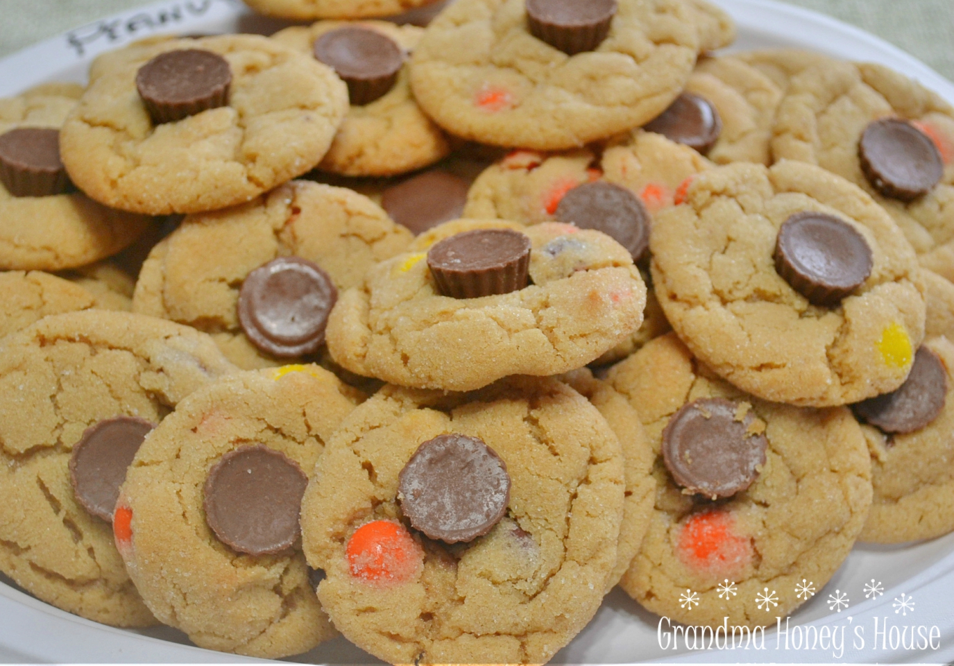 Triple Peanut Butter Cookie Delights are soft, chewy peanut butter cookies loaded with three favorite candies: Reese's Pieces, M&M's, and mini peanut butter cups. They are colorful, fun to make, and absolutely perfect for Halloween baking.