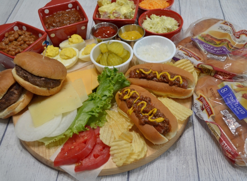 This cookout board for 2 includes burgers, hot dogs and all of the sides served at any summer get together.