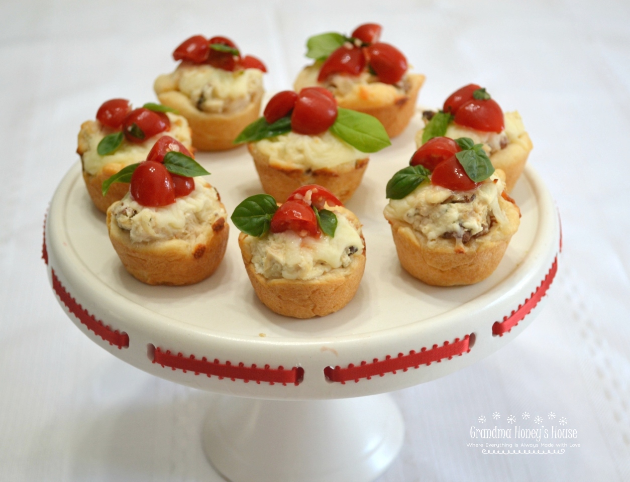 Chicken-Bacon-Caprese Bites are perfect to add to your tailgate menu. Chicken, cheese and a caprese topping baked in a crescent dough cup