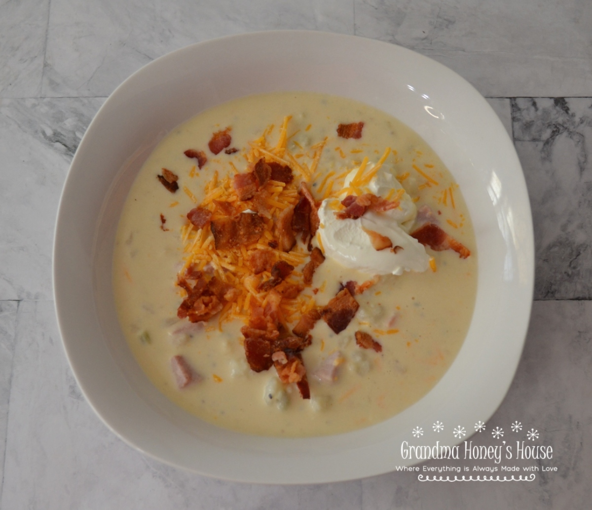 Loaded Baked Potato Soup, a pot full of potatoes, ham, cheese, bacon and veggies.