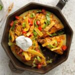 Taco Skillet Pizza is a cornbread crust filled with mexican themed ingredients.