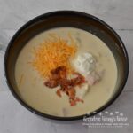 Loaded Baked Potato Soup, a pot full of potatoes, ham, cheese, bacon and veggies.