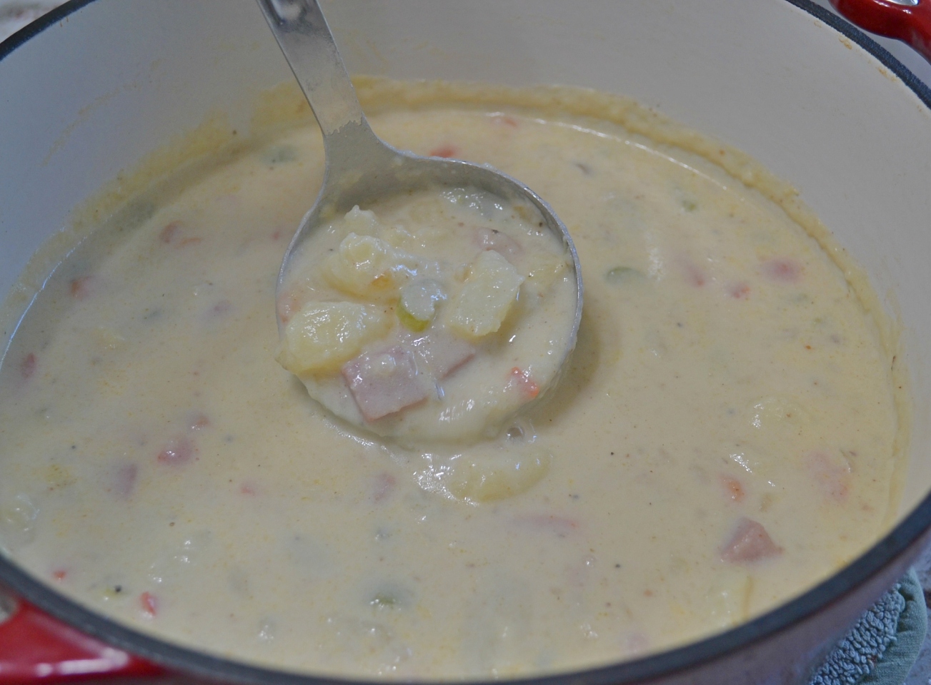 Loaded Baked Potato Soup, a pot full of potatoes, ham, cheese, bacon and veggies.