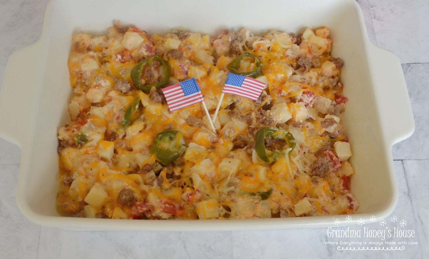 Firecracker Potato Casserole has Frozen Potatoes O Brien,  Rotel,  spicy sausage, sour cream, butter, jalapenos, and lots of cheese. Perfect for BBQ's.