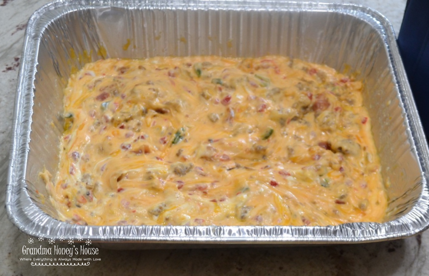 This Smoky Sausage Pimento Cheese Dip takes classic, creamy Southern pimento cheese and upgrades it with savory ground sausage, crispy bacon, and a kick of fresh jalapeño