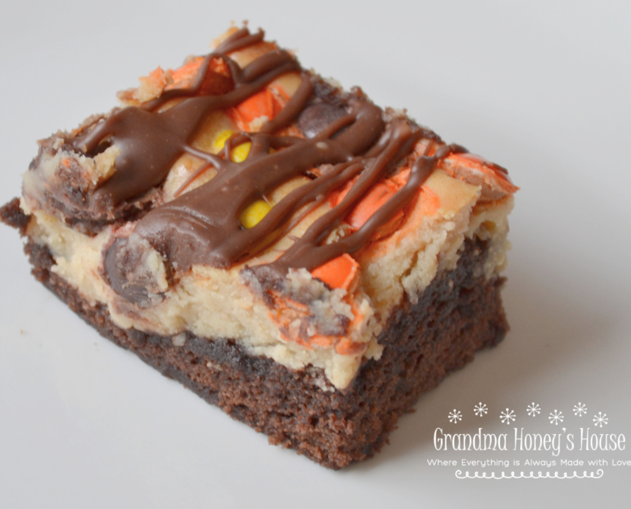 Extreme Peanut Butter Cream Cheese Brownies are extreme because they are a decadent brownie dessert, loaded with a peanut butter cream cheese layer, and then topped with a bag of Reese’s Baking Cups and Reese’s Pieces Candies