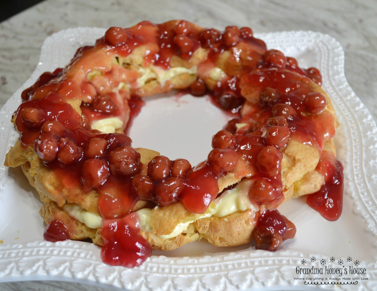 Cherry Cream Puff Ring, Inspired by a cherished family recipe, this cream puff ring is made with a light, airy pastry and filled with a creamy pudding mixture, then topped with sweet cherry pie filling. It’s a stunning dessert that looks impressive on any table but is surprisingly simple to make.
