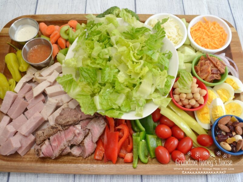 Super Chef Salad Served on a Board, Loaded with lettuce, veggies, meats and cheese. A complete meal.