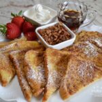 Thick slices of  brioche bread, soaked in a custard made of eggs, heavy cream, cinnamon, vanilla, nutmeg and salt, then fried in butter.  It is delicious served warm, with butter, syrup, confectioner sugar, and fresh fruit.