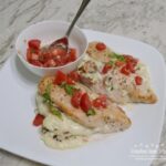 STUFFED CAPRESE CHICKEN BREASTS have a creamy filling of 3 cheeses, bacon, baby spinach, and parsley that make this dish so juicy. It is  baked and then topped with a balsamic tomato-basil topping.