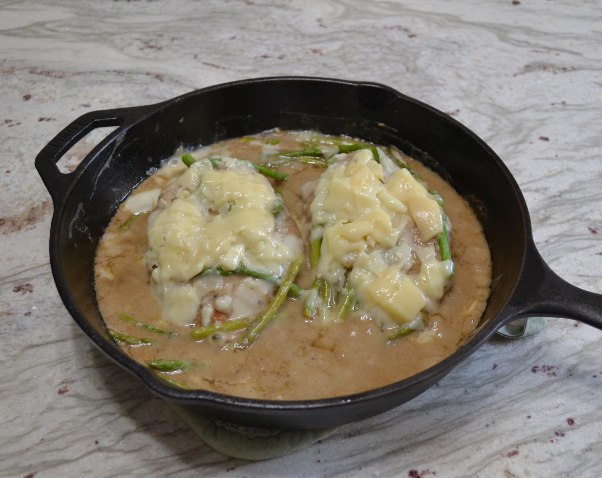 Cheesy Chicken Asparagus Dinner..pan fried chicken breasts, fresh asparagus, simmered in a white wine sauce and smothered with melted Italian cheeses.