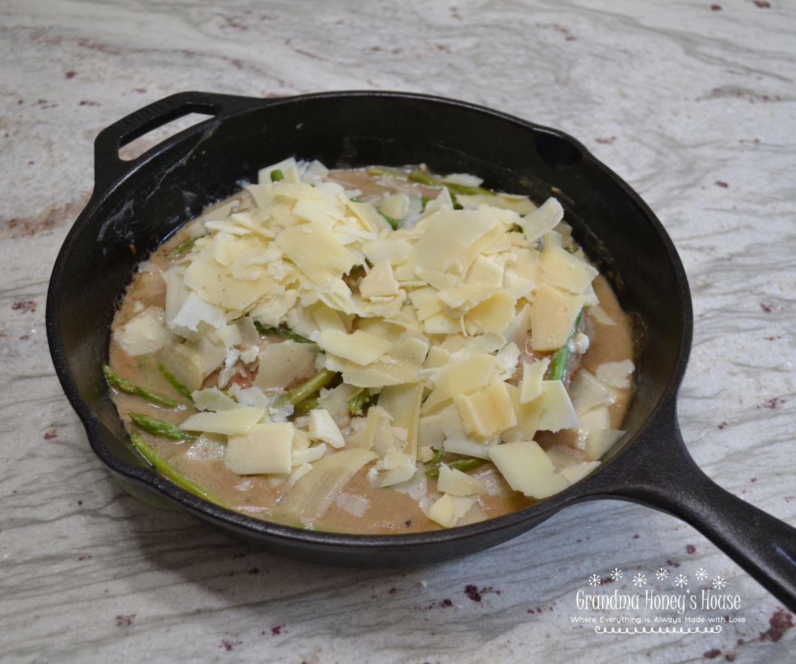 Cheesy Chicken Asparagus Dinner..pan fried chicken breasts, fresh asparagus, simmered in a white wine sauce and smothered with melted Italian cheeses.