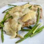 Cheesy Chicken Asparagus Dinner..pan fried chicken breasts, fresh asparagus, simmered in a white wine sauce and smothered with melted italian cheeses.