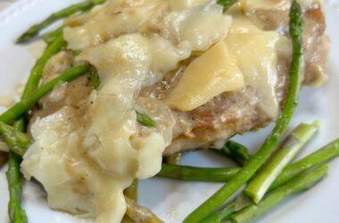 Cheesy Chicken Asparagus Dinner..pan fried chicken breasts, fresh asparagus, simmered in a white wine sauce and smothered with melted italian cheeses.
