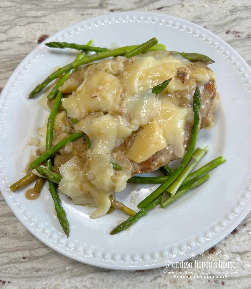 Cheesy Chicken Asparagus Dinner..pan fried chicken breasts, fresh asparagus, simmered in a white wine sauce and smothered with melted italian cheeses.