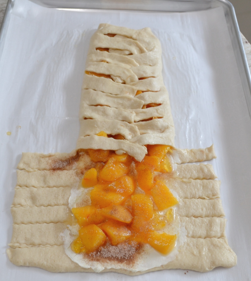 Peaches and Cream Crescent Braid...fresh peaches, cream cheese, sugar and cinnamon baked in a crescent  crust with a sweet glaze drizzled over it. 