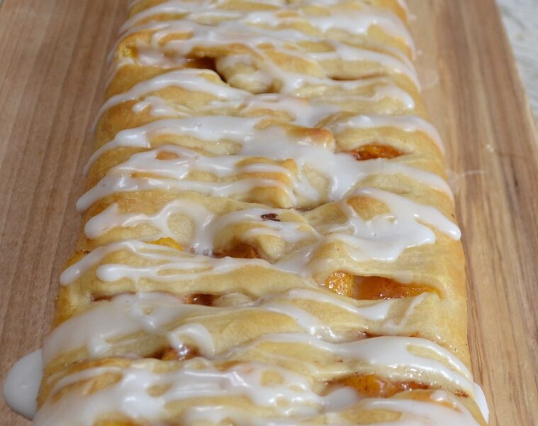 Peaches and Cream Crescent Braid...fresh peaches, cream cheese, sugar and cinnamon baked in a crescent  crust with a sweet glaze drizzled over it. 