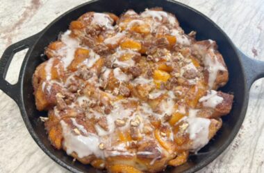 Cinnamon Roll Peach Cobbler Skillet.... a mixture of fresh peaches, cinnamon, sugar and vanilla, poured over a crust of refrigerated cinnamon rolls in a cast iron skillet and baked