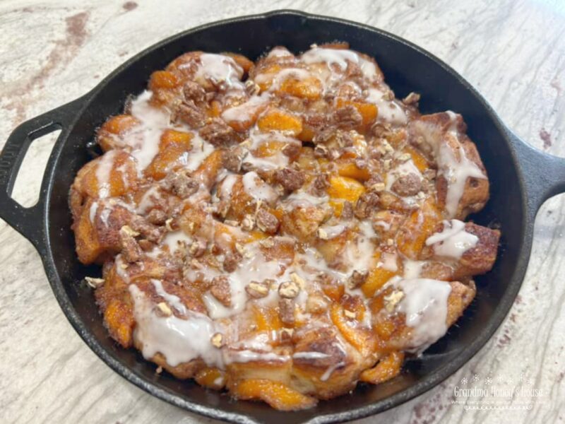 Cinnamon Roll Peach Cobbler Skillet.... a mixture of fresh peaches, cinnamon, sugar and vanilla, poured over a crust of refrigerated cinnamon rolls in a cast iron skillet and baked