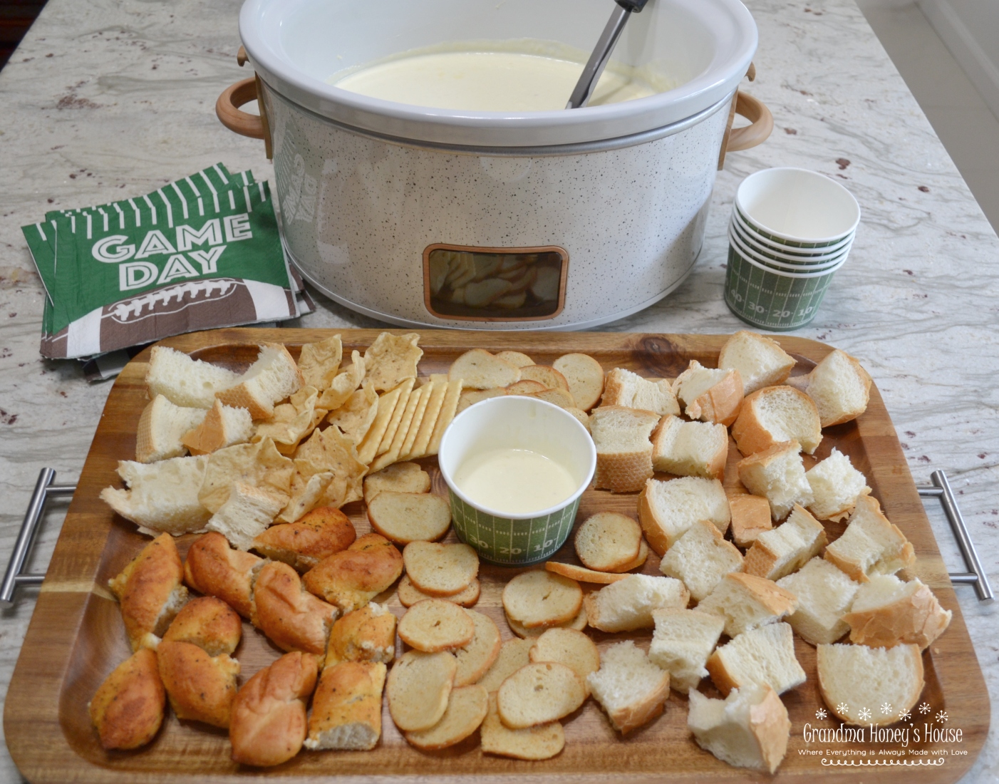 Garlic Parmesan Cheese Dip...a hot, creamy dip of melted cream cheese, minced garlic, whipping cream and parmesan cheese. Cubes of bread as dippers will make you think of a fondue. 