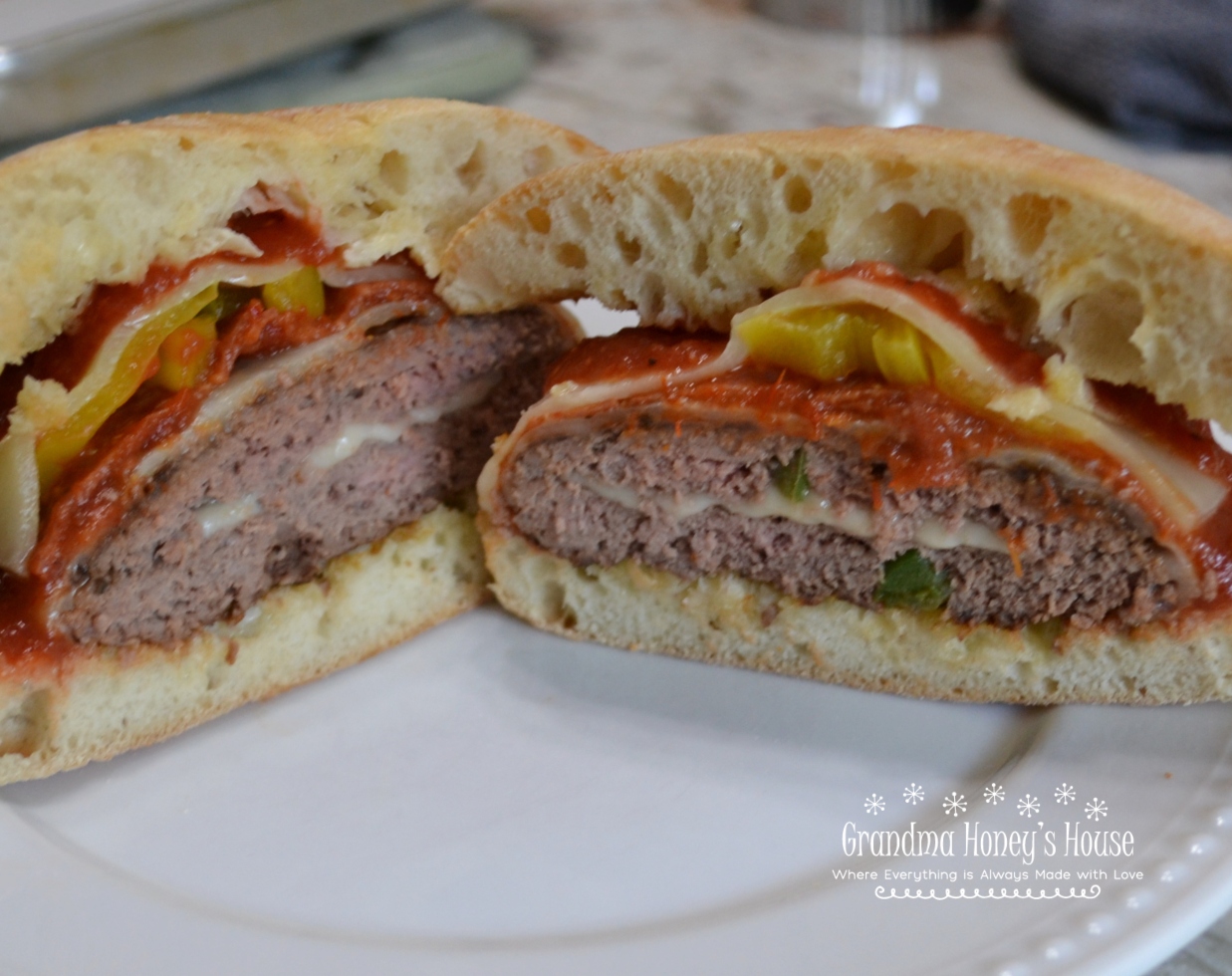 Pizza Burgers are seasoned ground beef patties, layered with mozzarella cheese, pepperoni, veggies, and topped with spoonfuls of warm pizza sauce. Serve on a garlic butter toasted bun.