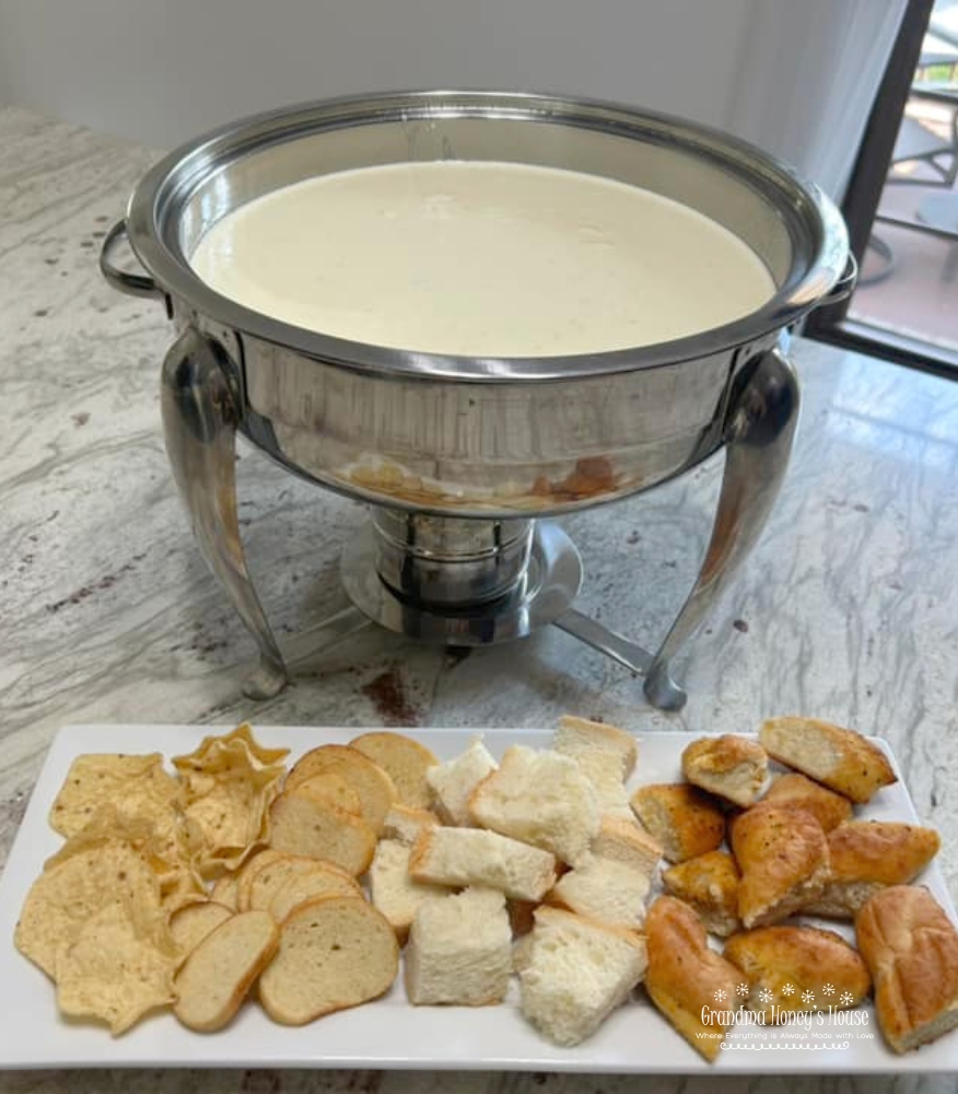 Garlic Parmesan Cheese Dip...a hot, creamy dip of melted cream cheese, minced garlic, whipping cream and parmesan cheese. Cubes of bread as dippers will make you think of a fondue. 