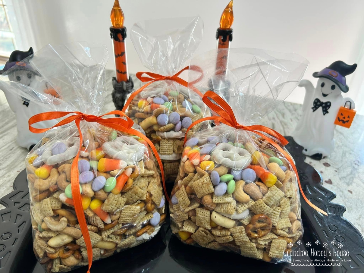 A combination of chex cereal, Gardetto's Original Snack Mix, cashews, yogurt pretzels, and a variety of candies make this Halloween Chex Mix the perfect treat. 