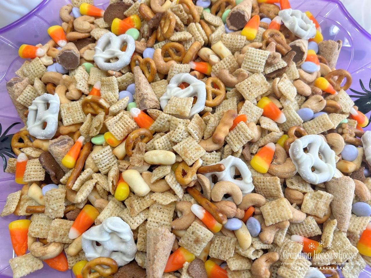 A combination of chex cereal, Gardetto's Original Snack Mix, cashews, yogurt pretzels, and a variety of candies make this Halloween Chex Mix the perfect treat. 