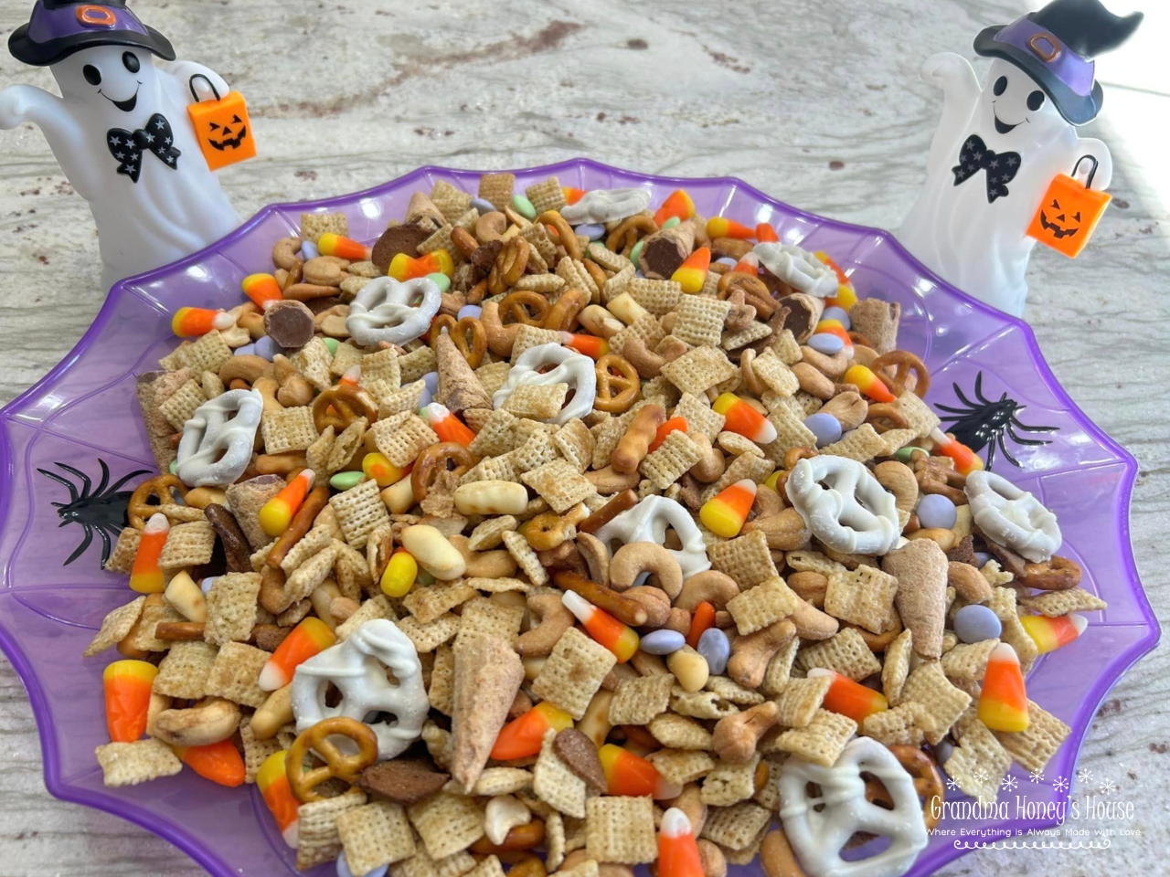 A combination of chex cereal, Gardetto's Original Snack Mix, cashews, yogurt pretzels, and a variety of candies make this Halloween Chex Mix the perfect treat. 