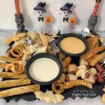 Halloween Fun-Due board is loaded with kid friendly appetizers and cheese dips.