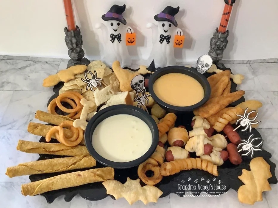 Halloween Fun-Due board is loaded with kid friendly appetizers and cheese dips. 